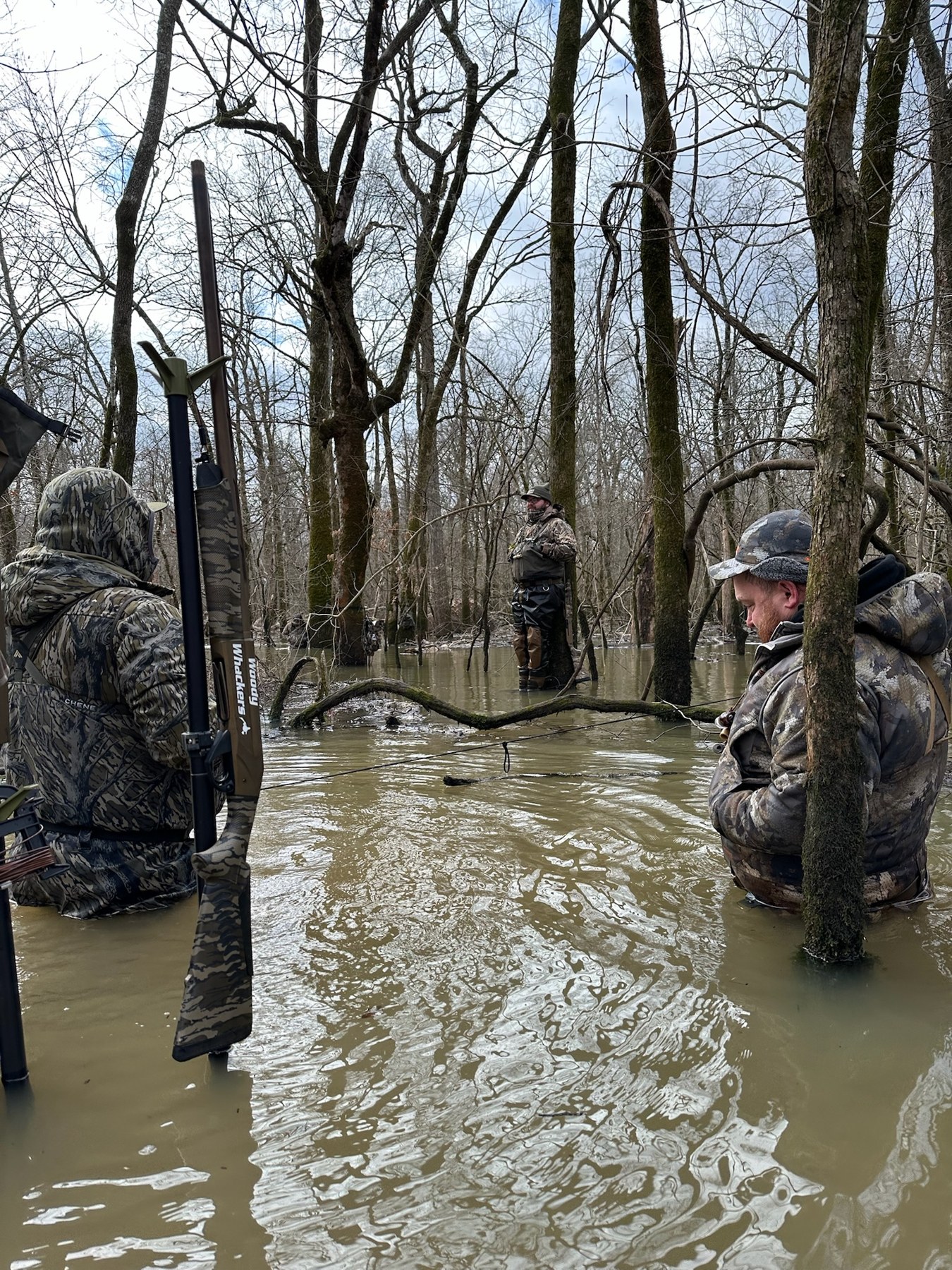 Hunters standing in flooded timber